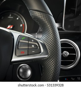 Hands Free And Media Control Buttons On The Steering Wheel In Black Leather Modern Car Interior