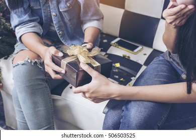 Hands Of Friend Giving A Christmas Gift To Friend.