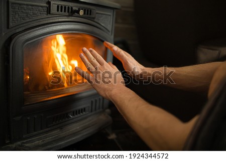 Hands In Front Of The Fire To Keep Warm