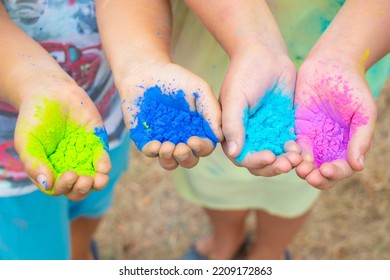 Childrenˇ's hands full of colorful holi powder used usually on celebrations in India or Run event in the Czech Republic.