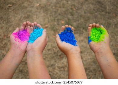 Childrenˇ's hands full of colorful holi powder used usually on celebrations in India or Run event in the Czech Republic. - Powered by Shutterstock