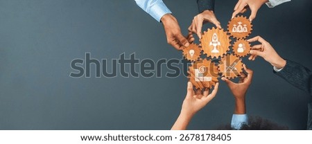 Hands gather around interlocking gears featuring icons that represent finance, innovation, and teamwork, symbolizing collaboration for business success and strategic growth. Amity