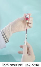 Hands Of General Practitioner Holding Syringe And Vial With Vaccine Against Coronavirus