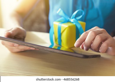 Hands With Gift Box And Digital Tablet