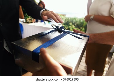 Hands With Gift Box On The Wedding Celebration