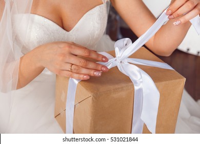 Hands With Gift Box On The Wedding Celebration. Studio Portraits Of Beautiful Bride With Gift .Bride Holding Gift