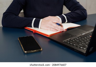 
Hands Of A Girl Behind A Laptop In A Pandemic. Remote Access Concept. Close-up. Selective Focus