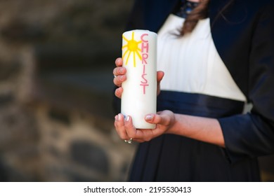 Hands Of Girl Holding Candle With Crucifix For Holy Confirmation Or Communion.