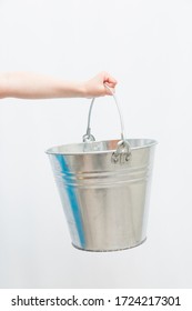 Hands of girl holding metal bucket. - Shutterstock ID 1724217301