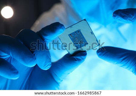 Hands in gloves hold chip testing microelectronics. Setting operating modes electronic controllers. Use chip tuning to increase power. Repair microprocessor electronics electrical equipment