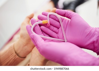 Hands In Gloves Holding Heart Shaped Clinical Pipes.