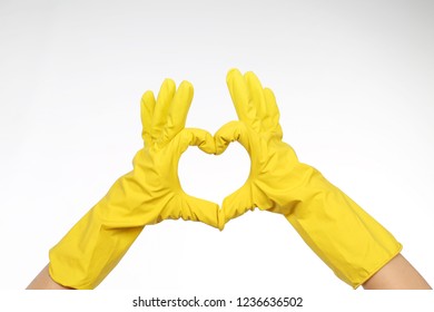 Hands In Gold Latex Rubber Gloves Show Heart On A White Background