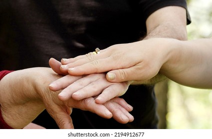 Hands Of A Grandma, Son, Daughter And Child Close-up, Hand In Hand. Next Generation Concept. Four Generation Together. 