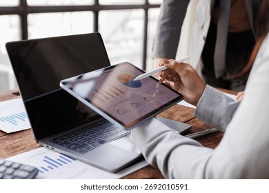 Hands and graphs on tablet screen for finance results, profit growth and budget review. Staff, team and digital with financial report, revenue stats and dividend comparison of risk assessment
