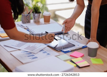 Hands and graphs on tablet screen for finance results, profit growth and budget review. Staff, team and digital with financial report, revenue stats and dividend comparison of risk assessment