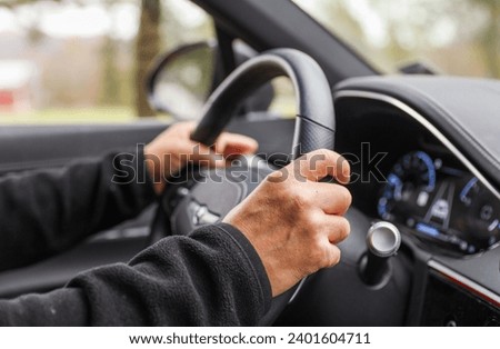 hands gripping a steering wheel, depicting control and navigation