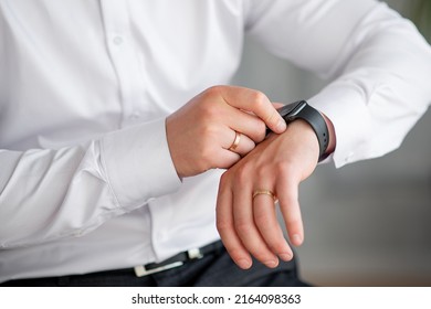 Hands Of The Groom In A White Shirt With A Watch And A Ring. Fees For Work Or Wedding. Close-up
