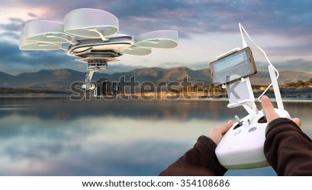 Hands guiding a drone through a remote control