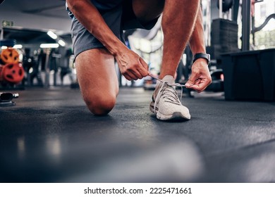 Hands, gym and man tie shoes preparing for training, running or exercise. Sports, fitness or male athlete in health studio getting ready for cardio, workout or bodybuilding practice in fitness center - Powered by Shutterstock