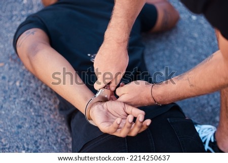 Hands, handcuffs and man on floor with police agent, justice and human rights in Iran to stop protest. Crime, law and freedom in arrest in street, criminal or thief arrested in city by police officer