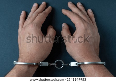 Hands with handcuffs and white background