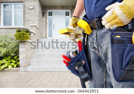 Hands of Handyman with a tool belt. 