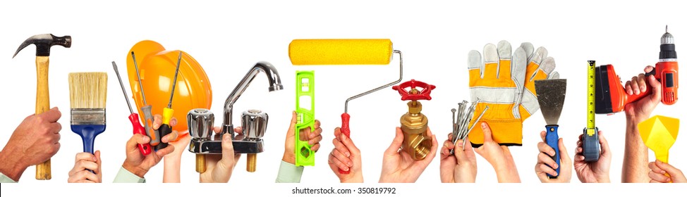 Hands Of Handyman With Tools. House Renovation And Construction.