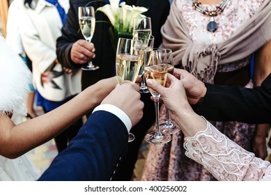 Hands Of Happy People Toasting And Cheering With Glasses Of Champagne, Celebrating Wedding, Luxury Life Concept