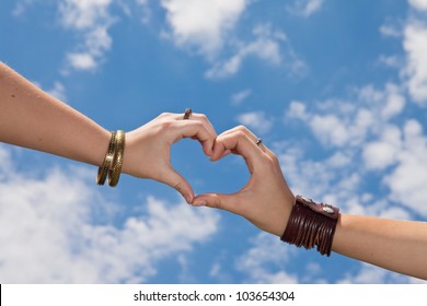 Hands As A Hart Shape On A Cloudy Sky - Love Concept