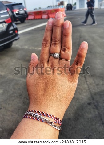 Hands of a healthy fat woman, her hands wear rings and bracelets.