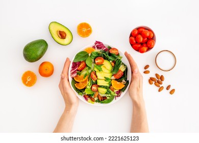 Hands with healthy lanch bowl. Vegan meal with avocado and tomato - Powered by Shutterstock