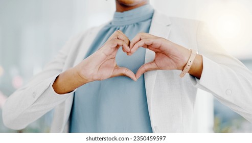Hands, heart and business woman with love emoji for care, kindness and symbol in office. Closeup of happy female worker with finger shape for thank you, trust and sign of hope, support icon and peace