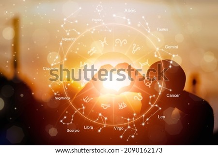 The hands are the heart shape with the sun light passing through the hands have astrological symbols