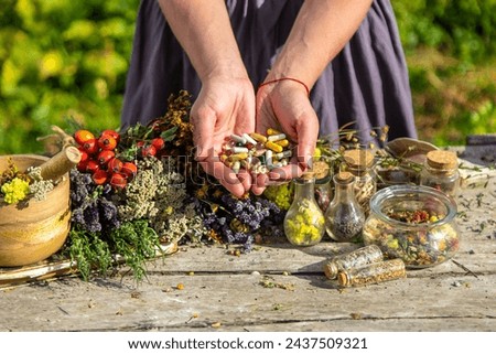 In the hands of herbs and supplements. Selective focus. Nature.