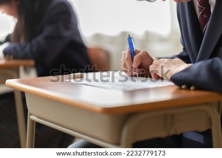 Hands of high school students during the test