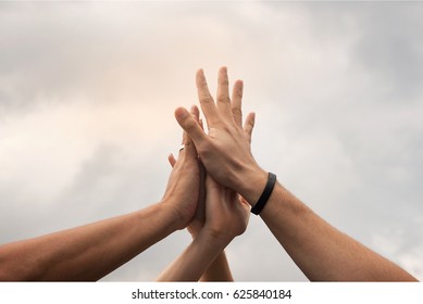 Hands Hit And Join Together In To Sky,after Everybody Success Something That They Do, Example Win In Game,success In Business,market Up Volume Sales.symbolizing To Trust Each Other. 