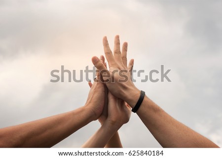 Hands hit and join together in to sky,after everybody success something that they do, example win in game,success in business,market up volume sales.symbolizing to trust each other. 