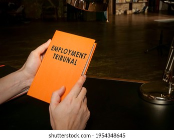 Hands Hold A Book About Employment Tribunal.