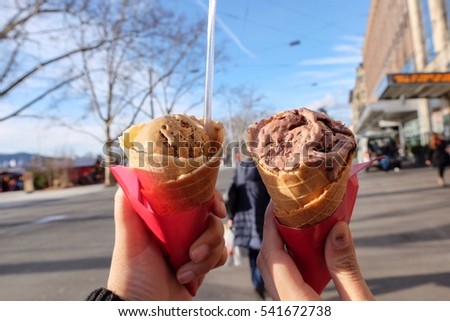 Hands hold Chocolate and Coffee favour Ice cream in holidays.