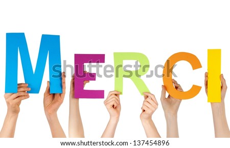 Hands hold the french word MERCI, which means thanks, isolated