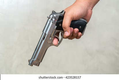 Hands Hold A Gun
