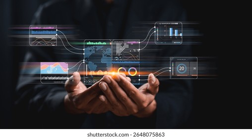 Hands hold a holographic interface displaying data charts, graphs, and analytics in a digital, futuristic business setting.