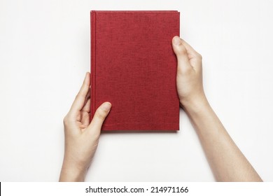 hands hold the red book(diary) cover isolated white.