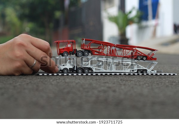 Hands\
Hold Red and White Scale Car Transporter Truck\
Toys