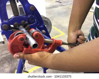 Hands Hold Or Using Steel Pipe Cutter Tool For Fast And Clean Pipe Cutting. Industrial Skill.