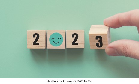 Hands Holding 2023 With Smile Face Wooden Blocks, Happy New Year, Positive Mental Health Plan, Optimistic Resolution Goal, Eco Sustainable Target Concept