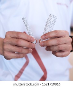 Hands Holding Aortic Stent Graft For People Education