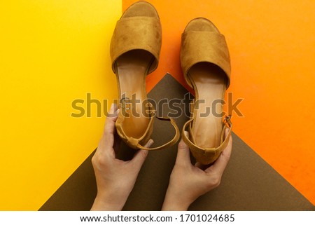 hands holding beautiful brown woman summer sundal isolated on color background
