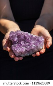 Hands Holding a Beautiful Large Amethyst Crystal