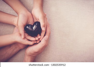 Hands Holding Black Heart, Health Insurance, Mending Broken Family, Children Mental Illness Health, Autism Spectrum Disorder, BLACK LIVES MATTER, NO RACISM  Concept